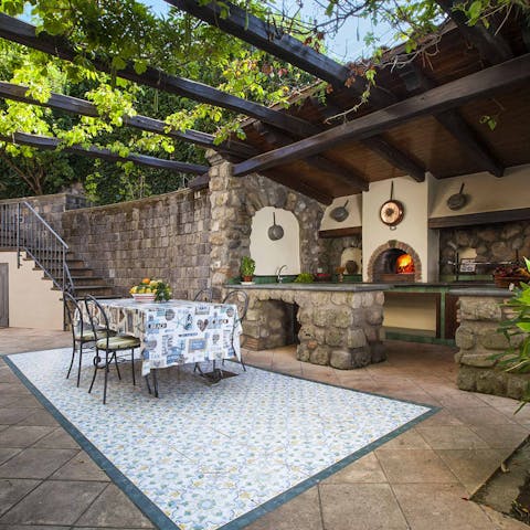 Enjoy alfresco meals under the vine-covered pergola