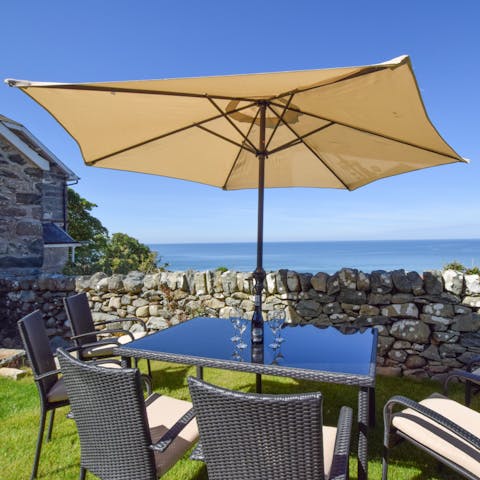 Enjoy a glass of wine and uninterrupted sea views from your private garden