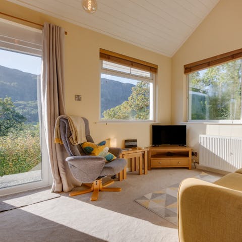 Relax on the sofa as you look out to dramatic views of the forests