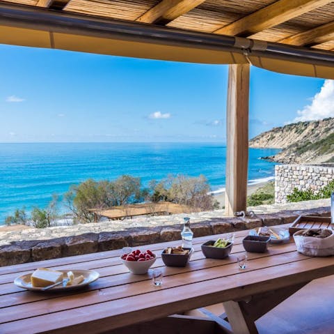 Dine alfresco under the shaded pergola with beautiful sea views