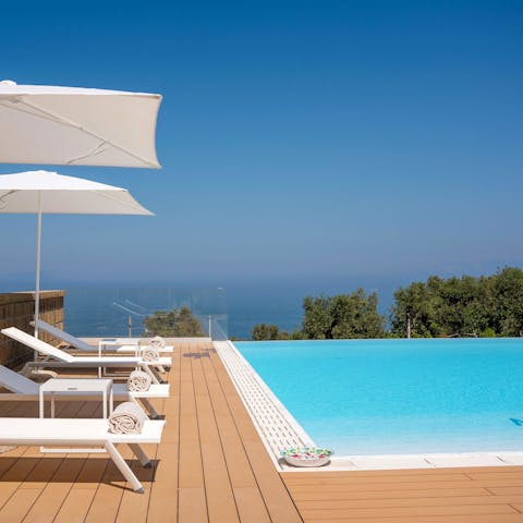 Lie back by the pool and admire the sea views