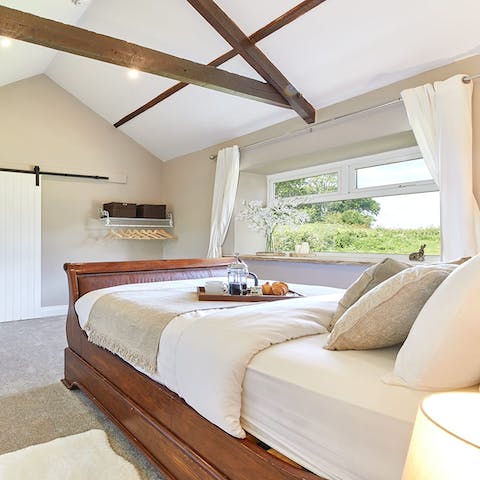 Wake up to country views in the sleigh bed