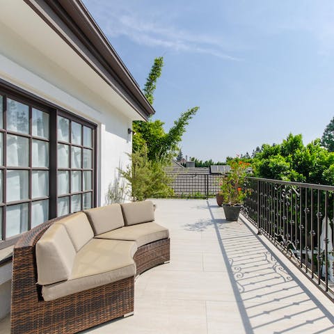 Seclude yourself away on the balcony overlooking the garden