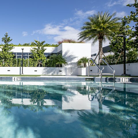 Beat the heat with a dip in the sparkling outdoor pool, circled by swaying palm trees
