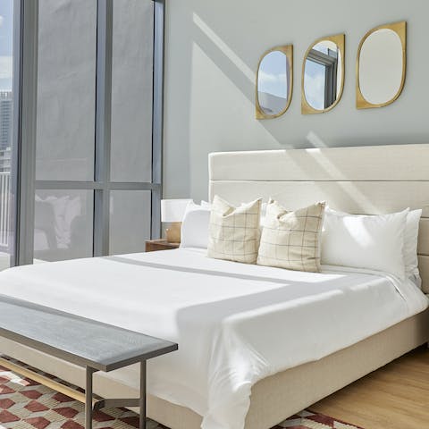 Wake up to sunlight flooding through the floor-to-ceiling windows in the stylish bedrooms