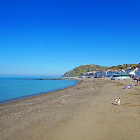 Spend afternoons frolicking on Llanrhystud Beach, less than a twenty-five-minute drive away