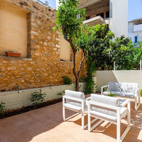 Gather in the outdoor lounge to share a glass of wine and some local olives