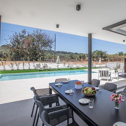 Enjoy a bite to eat on the shaded terrace overlooking the pool