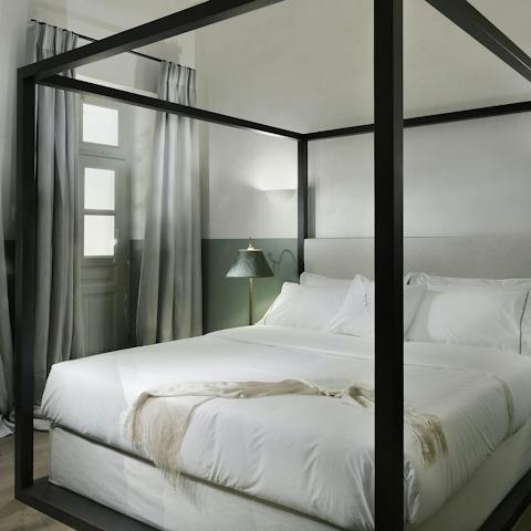 Get some rest in the four-poster bed after a busy day in Athens