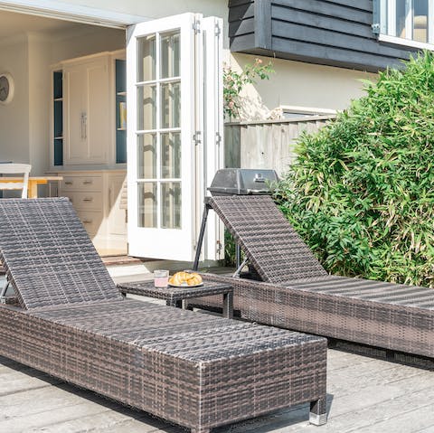 Sunbathe on loungers in the private garden