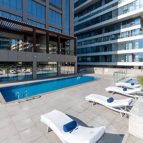 Stretch out poolside before enjoying a cooling dip in the shared pool
