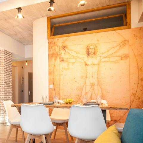 Plan your excursions in a New York-style apartment, dining beside classical wall art