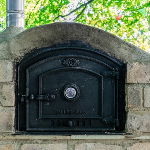 Cook a feast for the family in the stone-built pizza oven