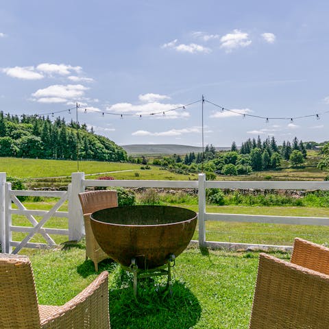 Gather around the fire pit and watch the sun set over Dartmoor National Park