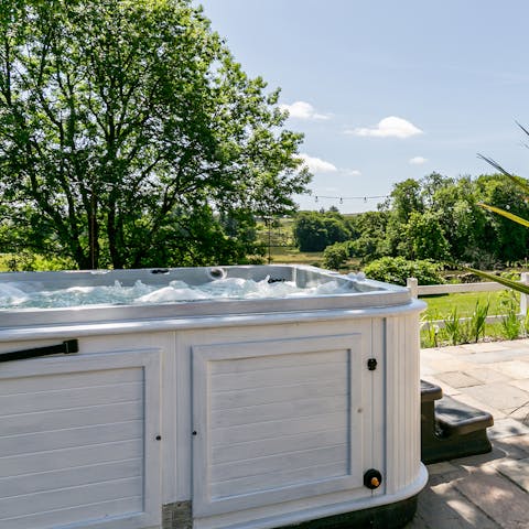 Slip into the bubbling hot tub and admire the scenery around you