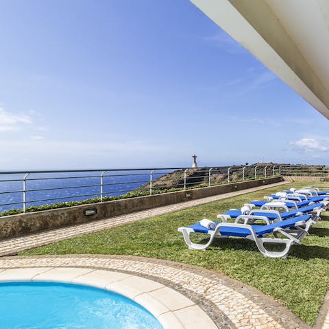 Kick back in your cliffside sun lounger and enjoy the stunning panoramic views of the coastline