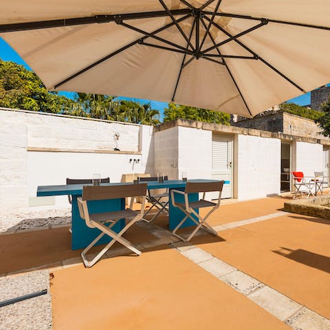 Sip cocktails with friends under the shade of the parasol 