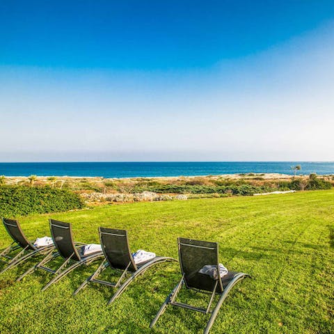 Sit back and admire stunning sea views from the privacy of the expansive garden
