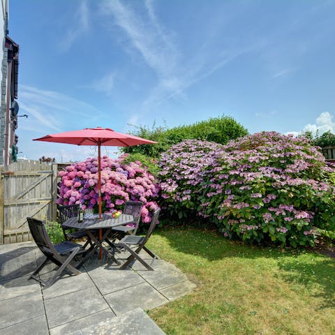 Sit out among the flowers in the home's peaceful garden