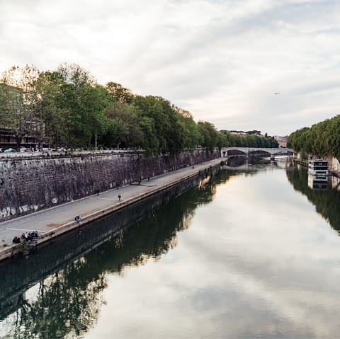 Take an early evening stroll along the Tiber River, just two minutes from your door