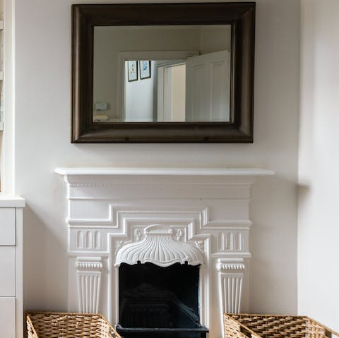Admire the decorative plasterwork of the fireplace