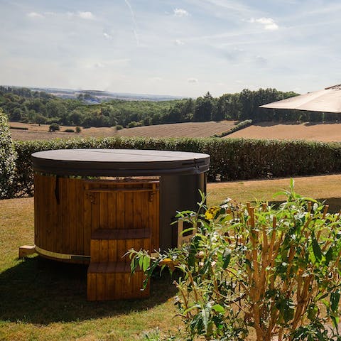 Unwind in the wood-fired hot tub as the sun begins to set