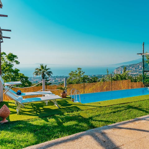 Relax on a poolside lounger while taking in the views before having a dip in the pool