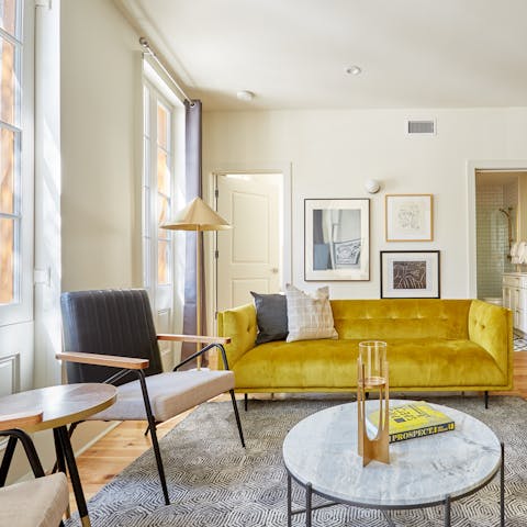 Mix your favourite cocktail and relax on the bright yellow velvet sofa