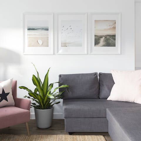Find a cosy spot to unwind with a good book in the pastel pink living room