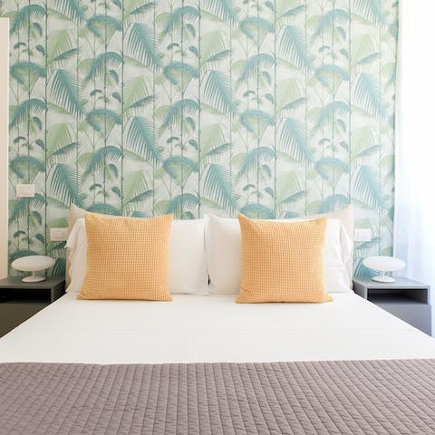 Drift off surrounded by palm prints in soothing shades of green in your restful bedroom 