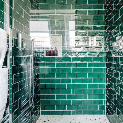 Start mornings with a luxurious soak in the emerald-green tiled shower