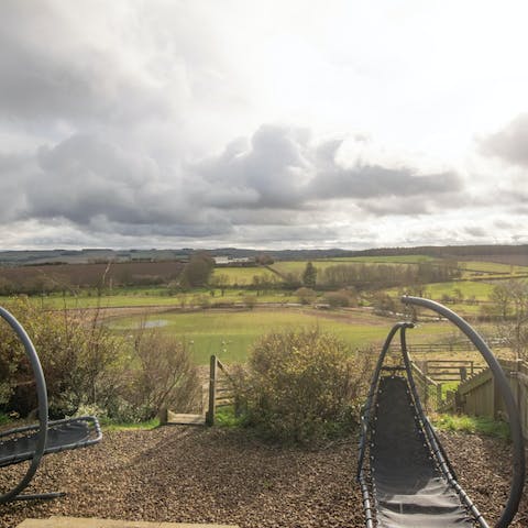 Enjoy turning pages of your holiday read from the garden swing seat