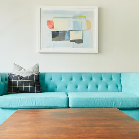 Lounge on the powder blue sofa with your favourite cocktail in hand