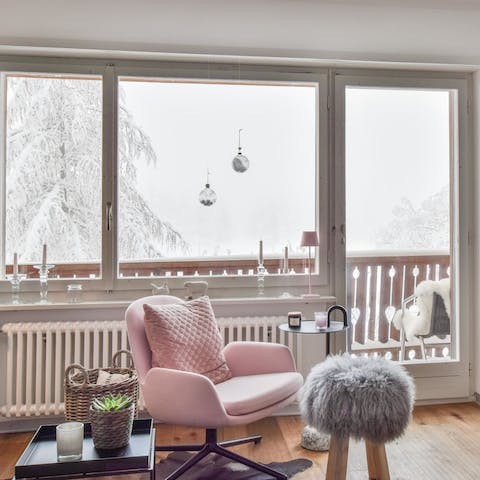 Curl up on the blush-coloured chair with a cup of cocoa and watch the snow fall out the window