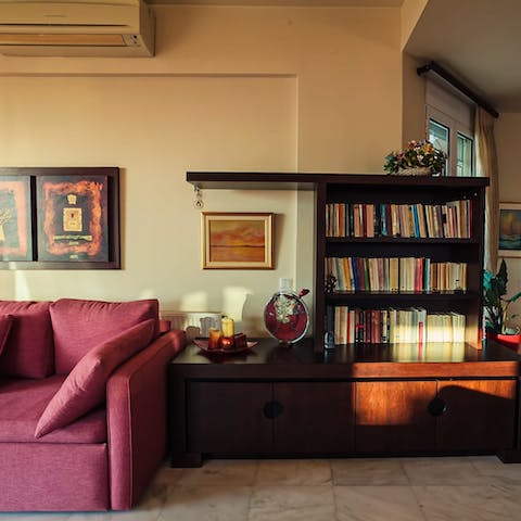 Choose a novel from the bookshelf and put your feet up on this fuschia-coloured sofa