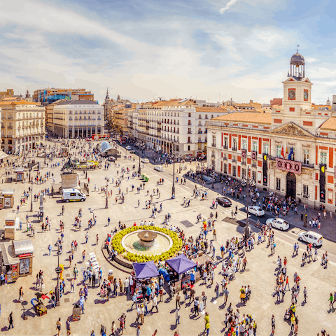 Wander the beautiful Puerta del Sol, a sixteen-minute walk away