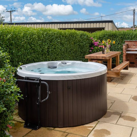 Get properly relaxed with a soak in the garden hot tub