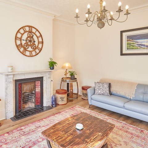 Relax in the stylishly decorated living room beside the crackling fireplace