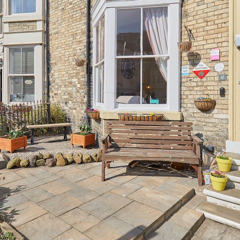 Enjoy your morning coffee on your bench, surrounded by plants and the sounds of seagulls