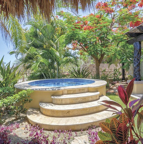 Relax in the hot tub among the verdant foliage