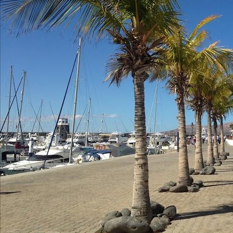 Stroll along the Puerto Calero marina promenade, soaking up the sea vistas