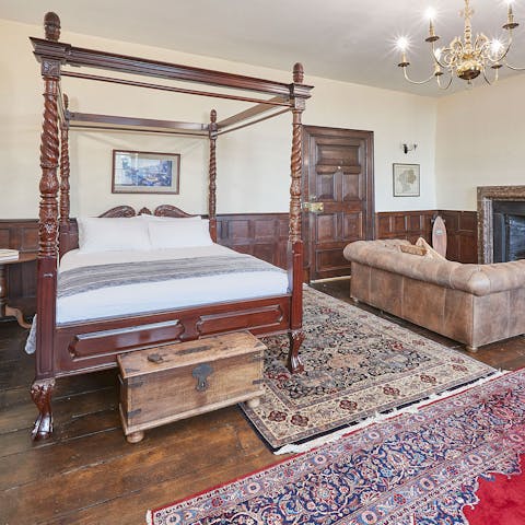 Sleep like royalty in one of the home's two four-poster beds