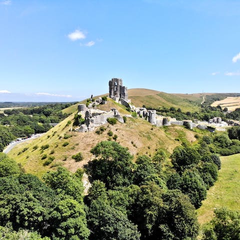 Visit Corfe Castle ruins by seasonal steam train, departing from this town