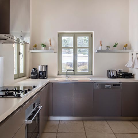 Hire a professional chef to come and cook Greek moussaka in this sleek kitchen