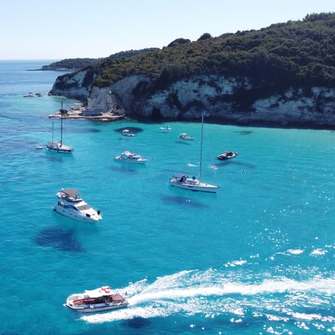 Explore the island's secluded coves and hidden caves by motorboat